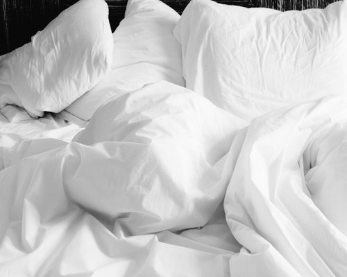 Person resting feet elevated on a soft cushion at home